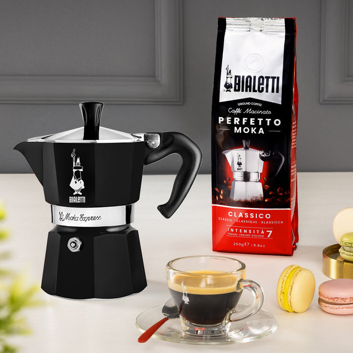 black bialetti moka express and bag of coffee