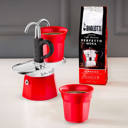 Red Bialetti mini express with bag of italian ground coffee