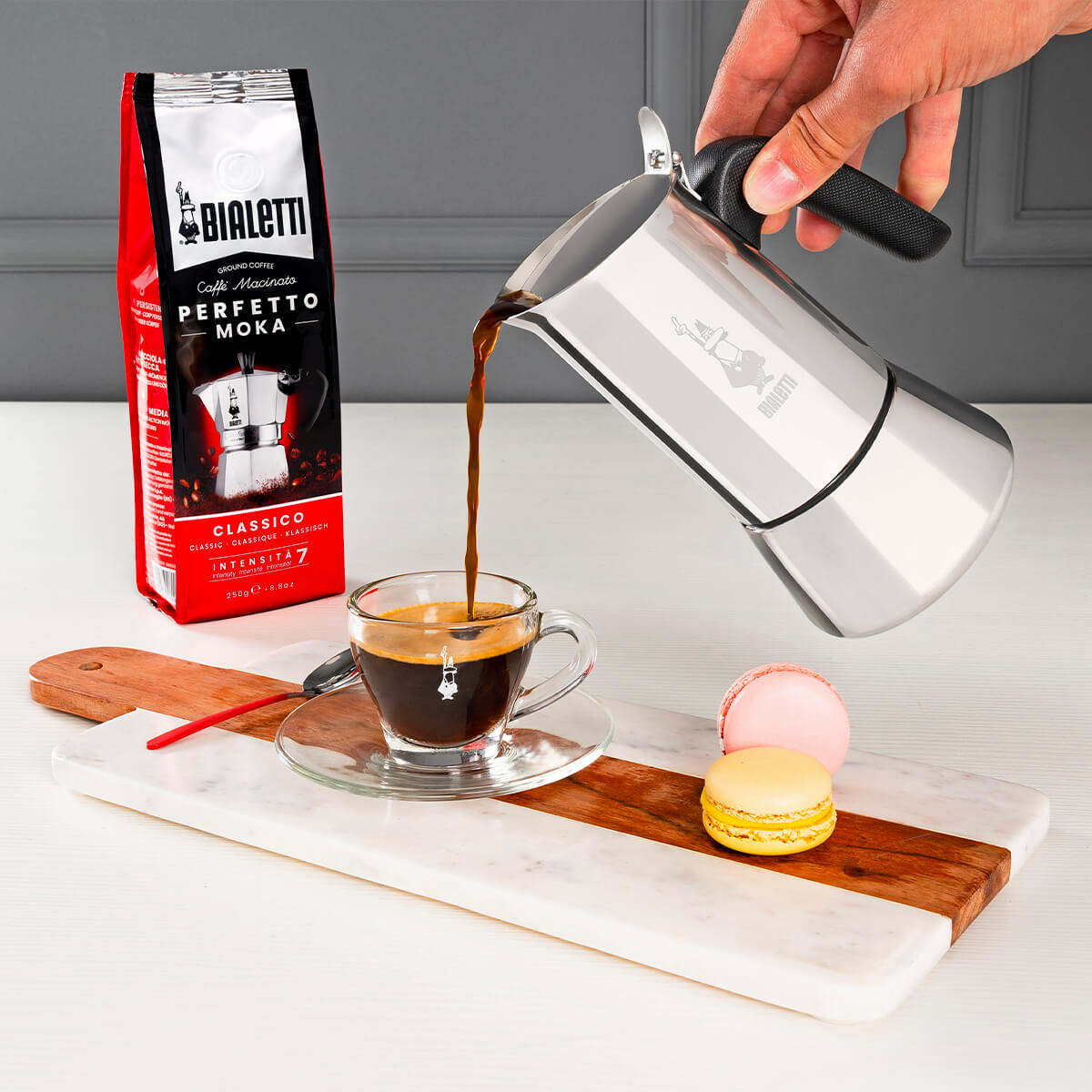 Pouring a cup of fresh italian coffee from Bialetti induction friendly coffee maker Venus stainless steel range